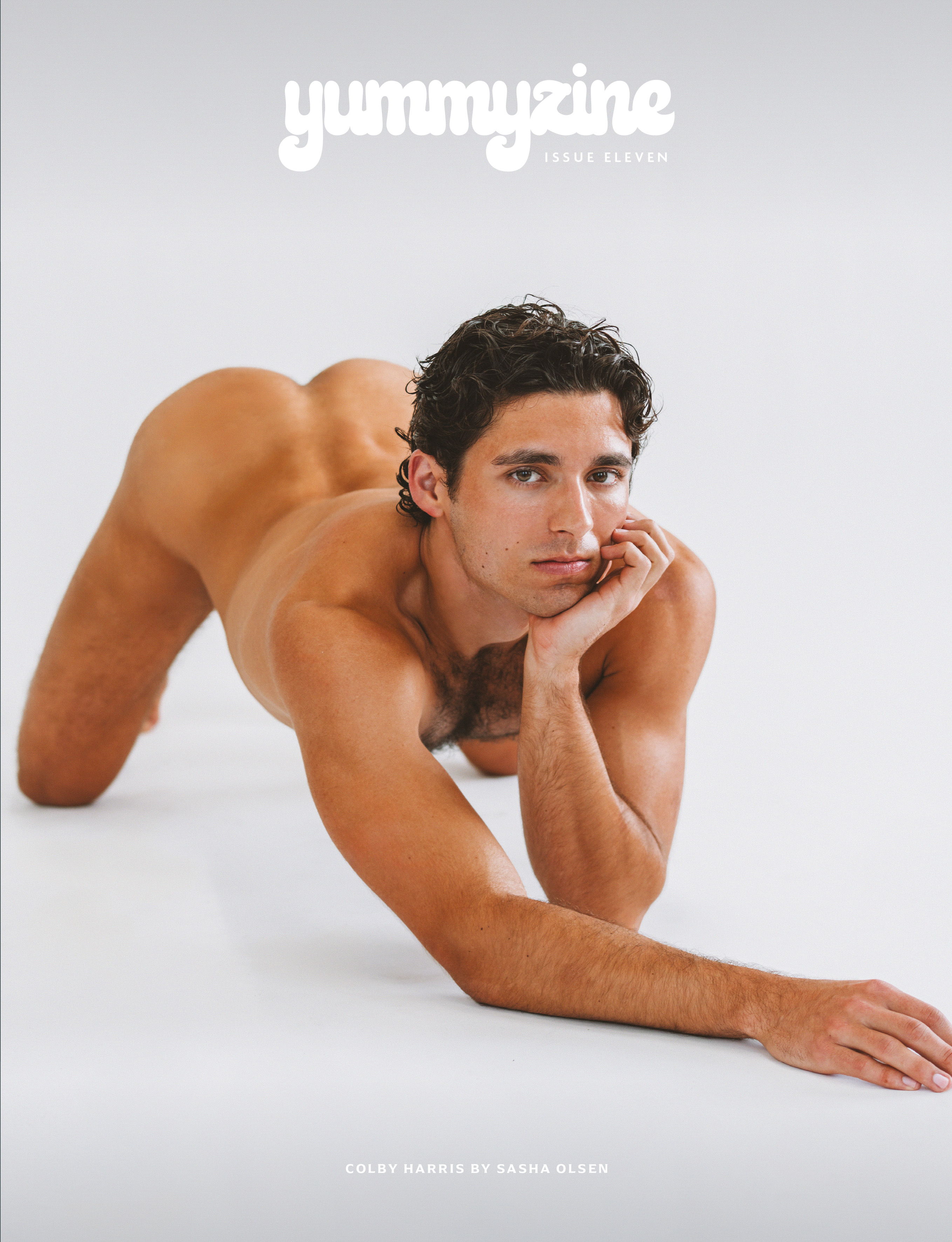 Young man posing nude on a white background.