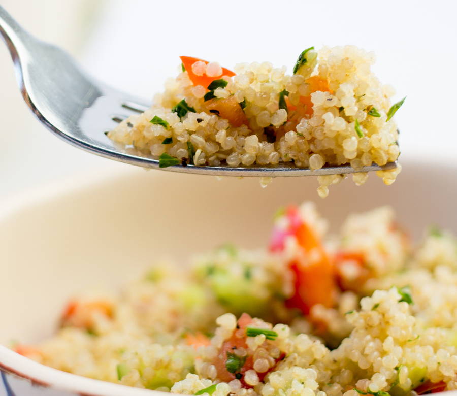up close fork full of quinoa salad