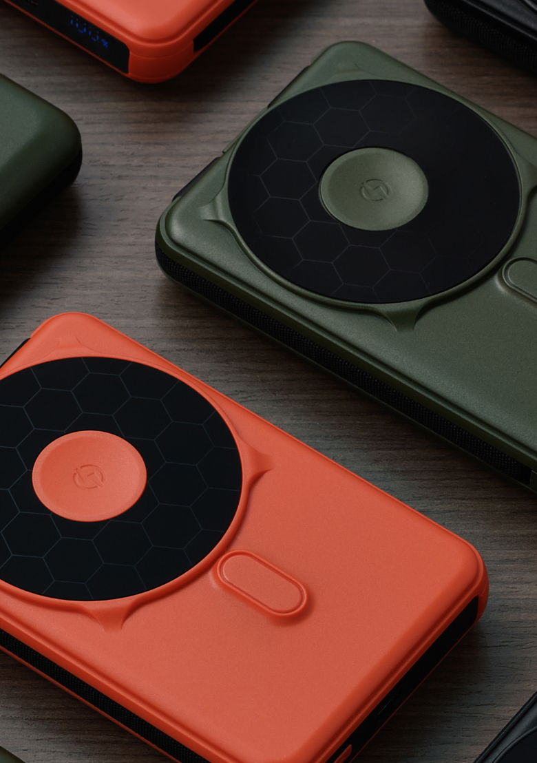 Various phone cases with circular designs on a wooden surface.