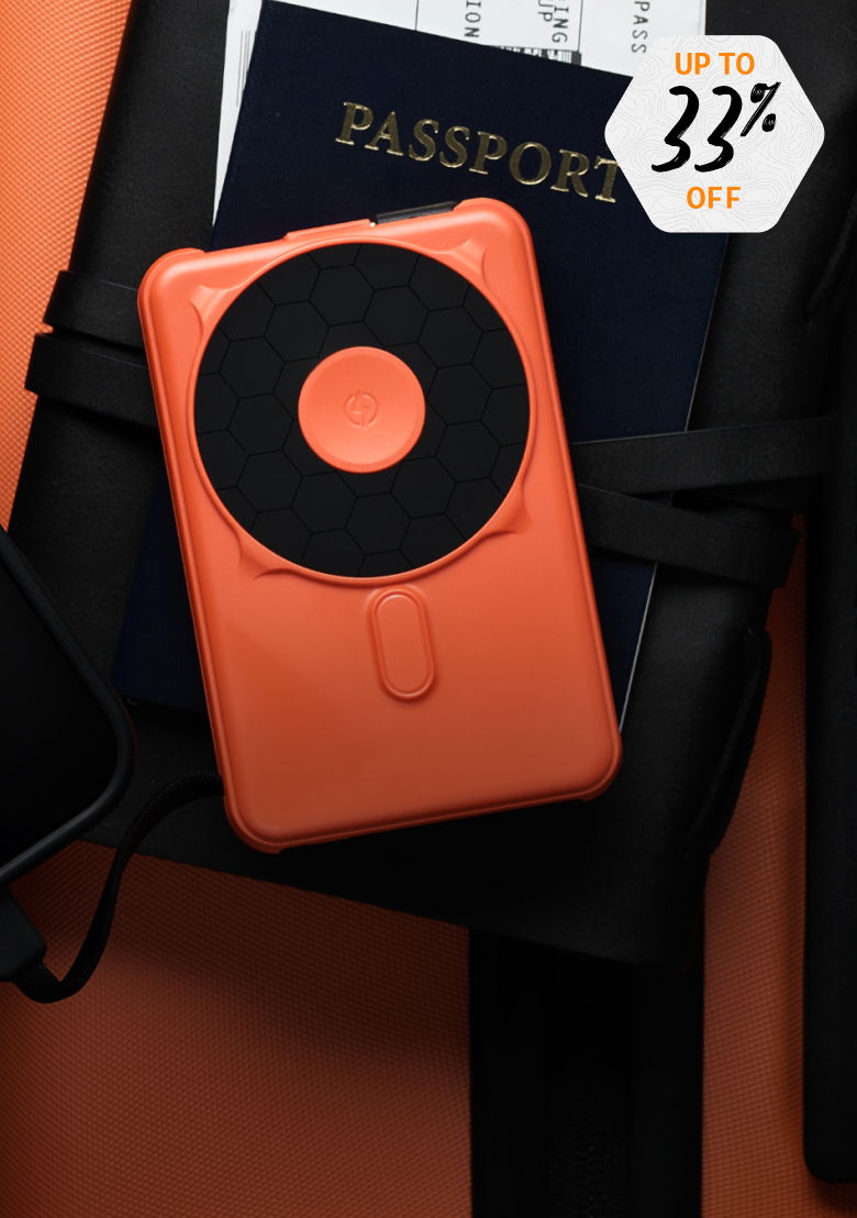 An orange portable device next to a passport on an orange background.