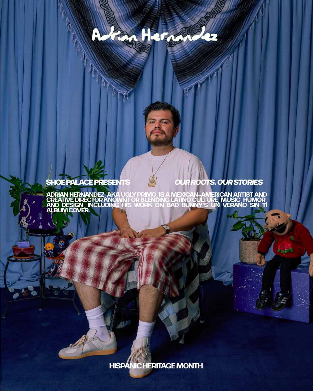 A man seated in front of a blue backdrop with text about Hispanic Heritage Month.