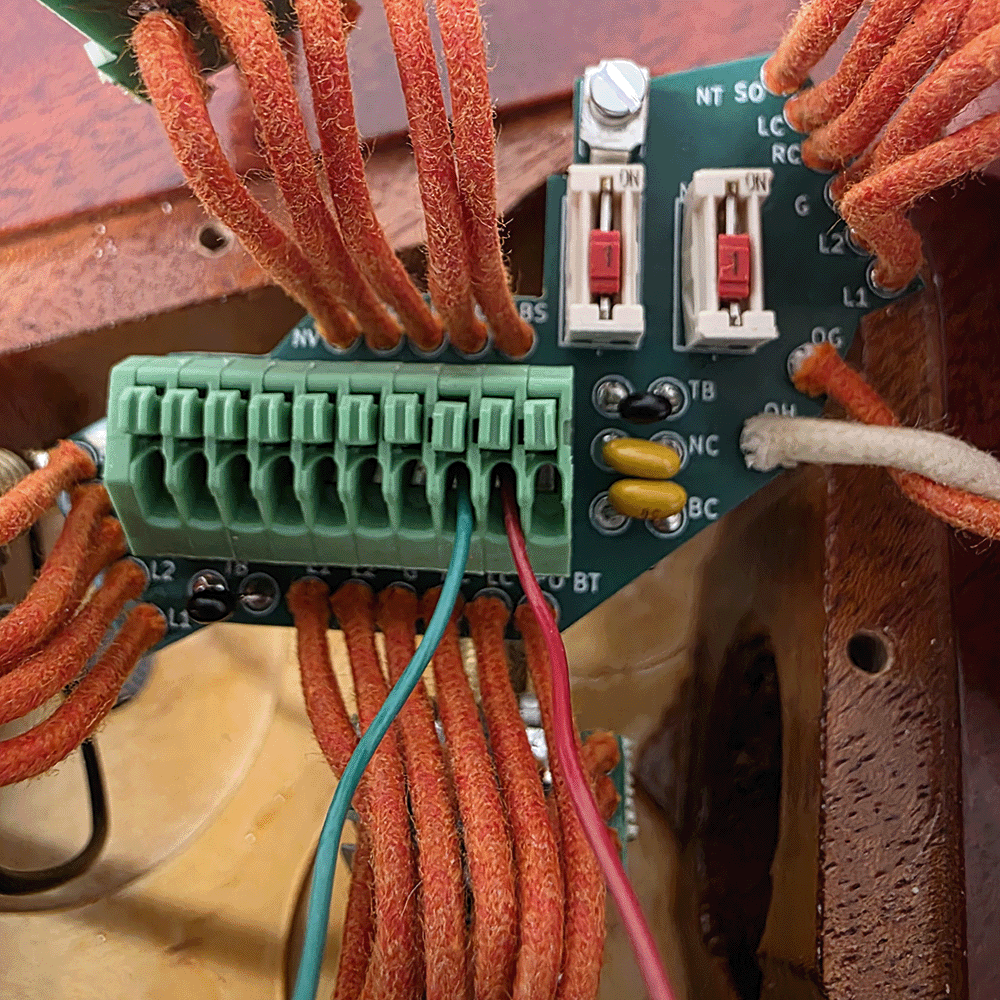 Wires connected to a circuit board with various terminals and connectors.