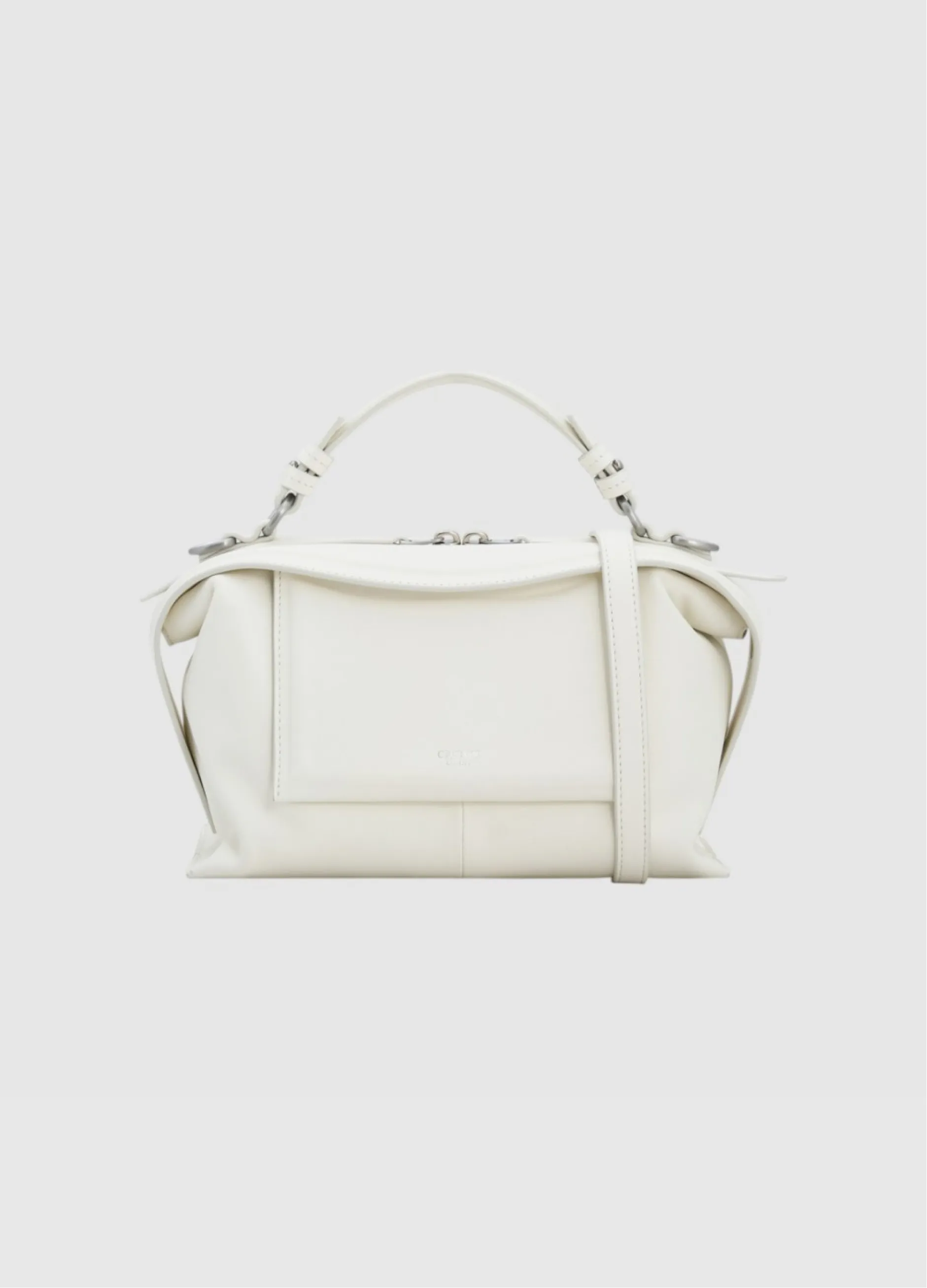 White leather handbag with a structured design and detachable shoulder strap.
