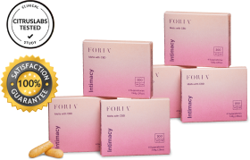Six boxes of Foria Intimacy Melts with pink packaging design, two boxes stacked on top of the other four, plus two loose melts resting up against one of the boxes.