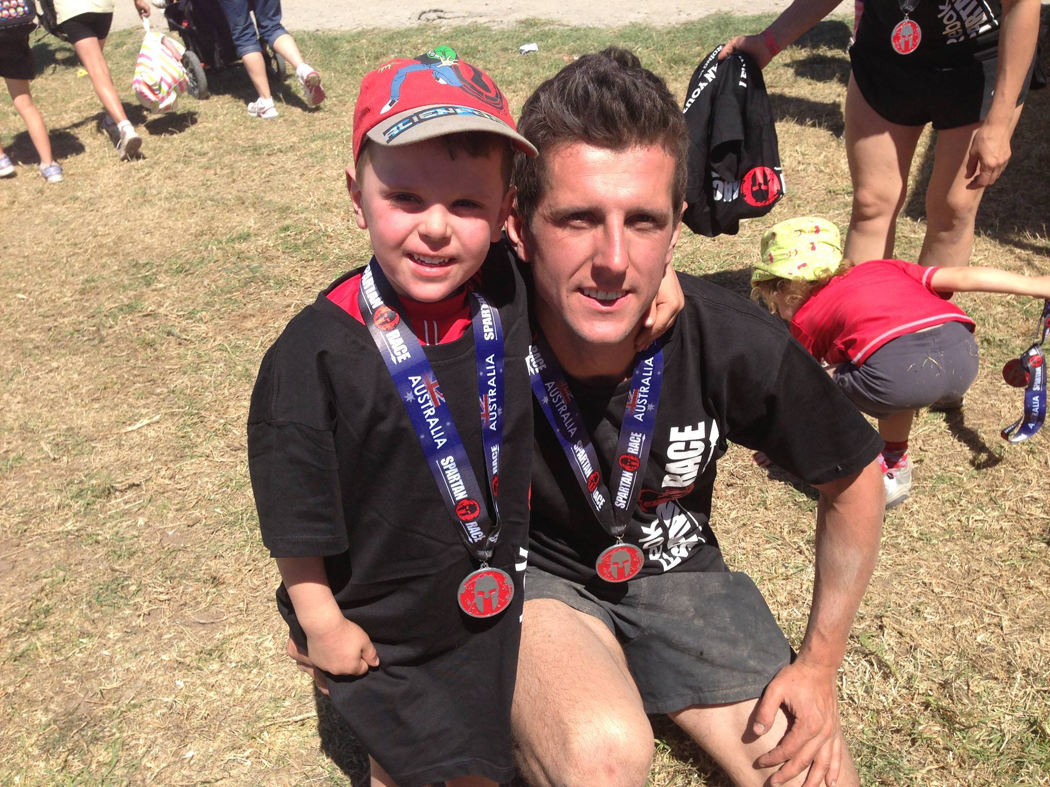 Tim holding Oliver as a child after just completing Ultra Marathon