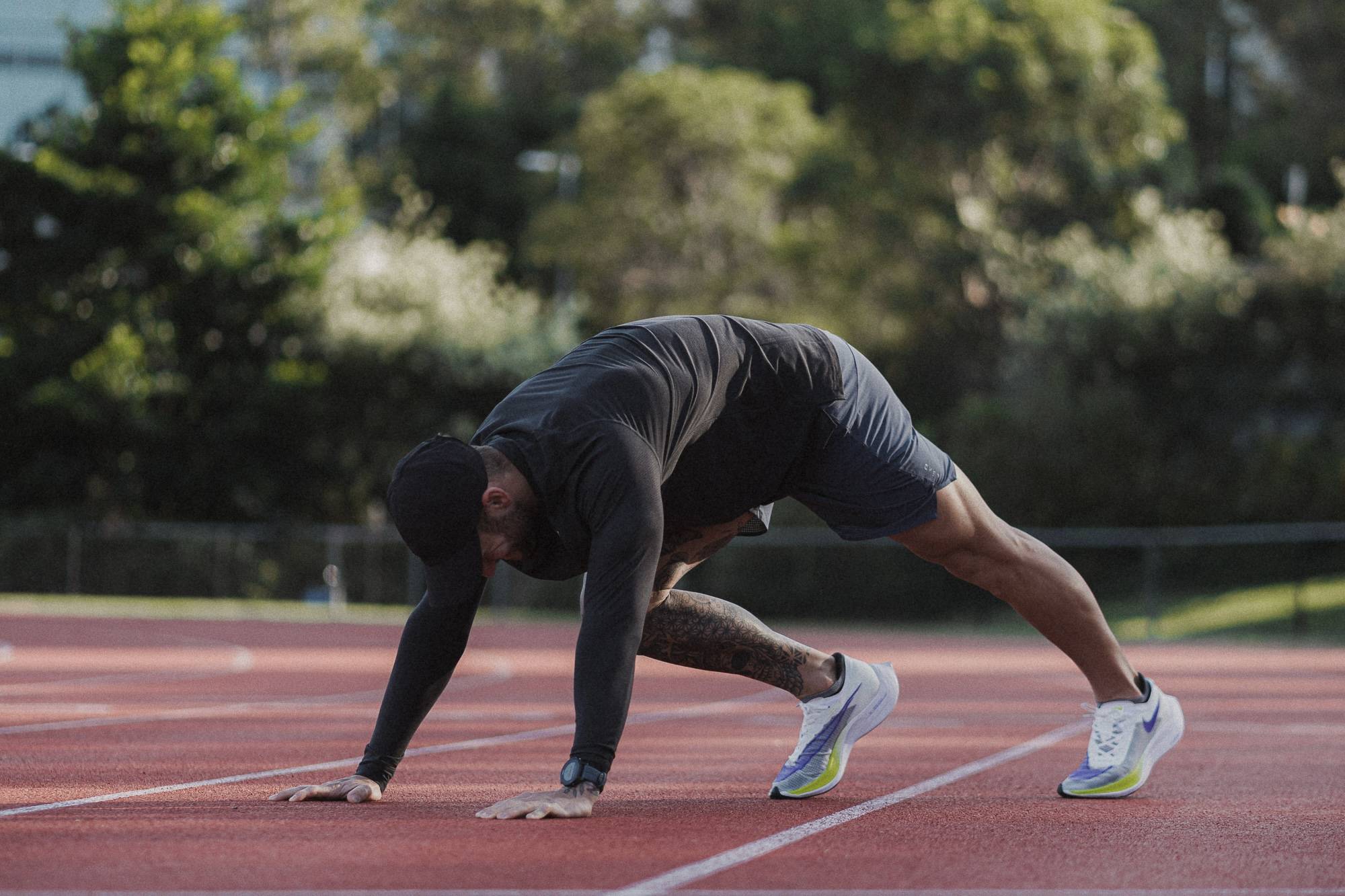 man stretching at the track