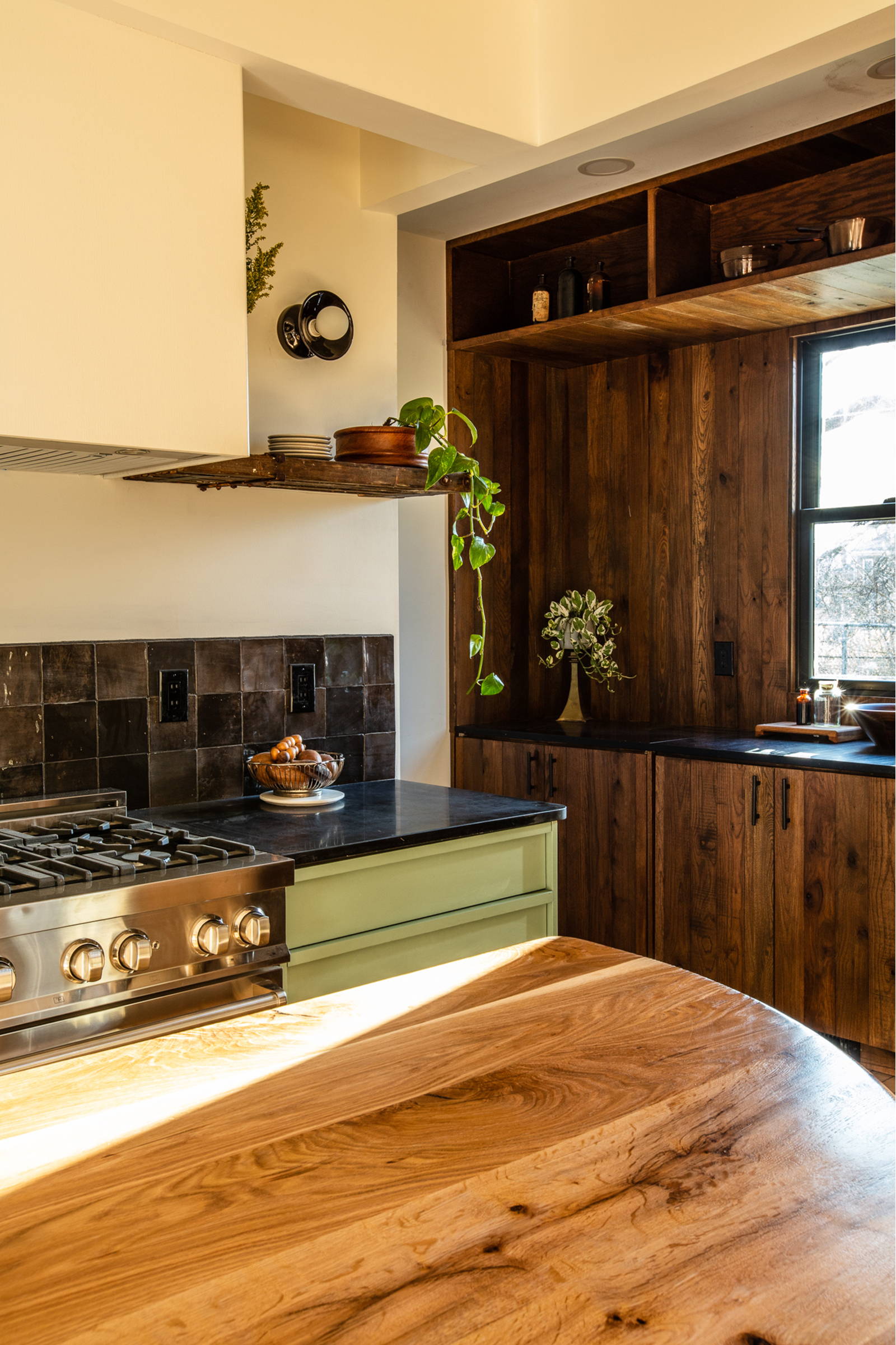 Modern kitchen interior design, featuring cabinet and wall cladding made from reclaimed wood rom Woodward Throwbacks.