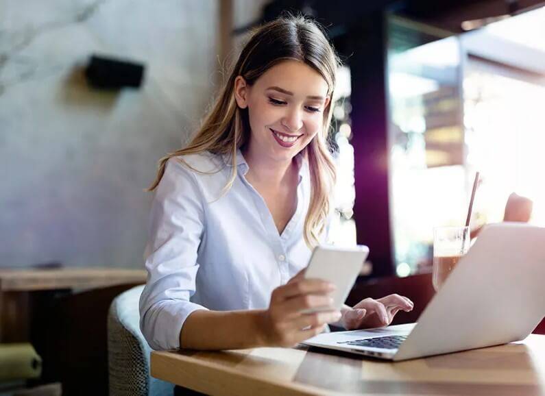 Smiling woman looking at her phone