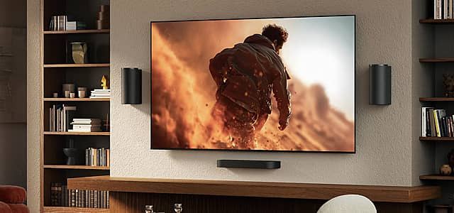 A person walking through smoke displayed on an RGB LED TV in a living room.
