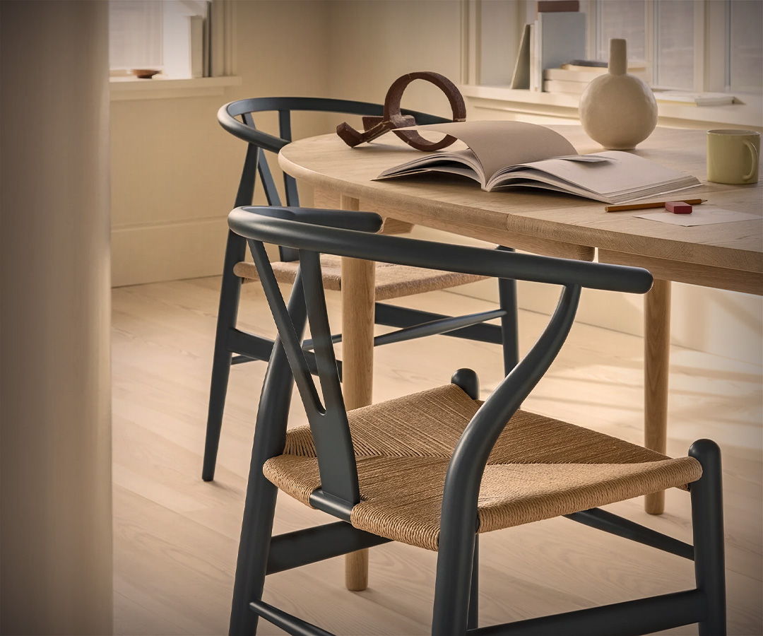 A stylish Carl Hansen dining area with a wooden table and two chairs.