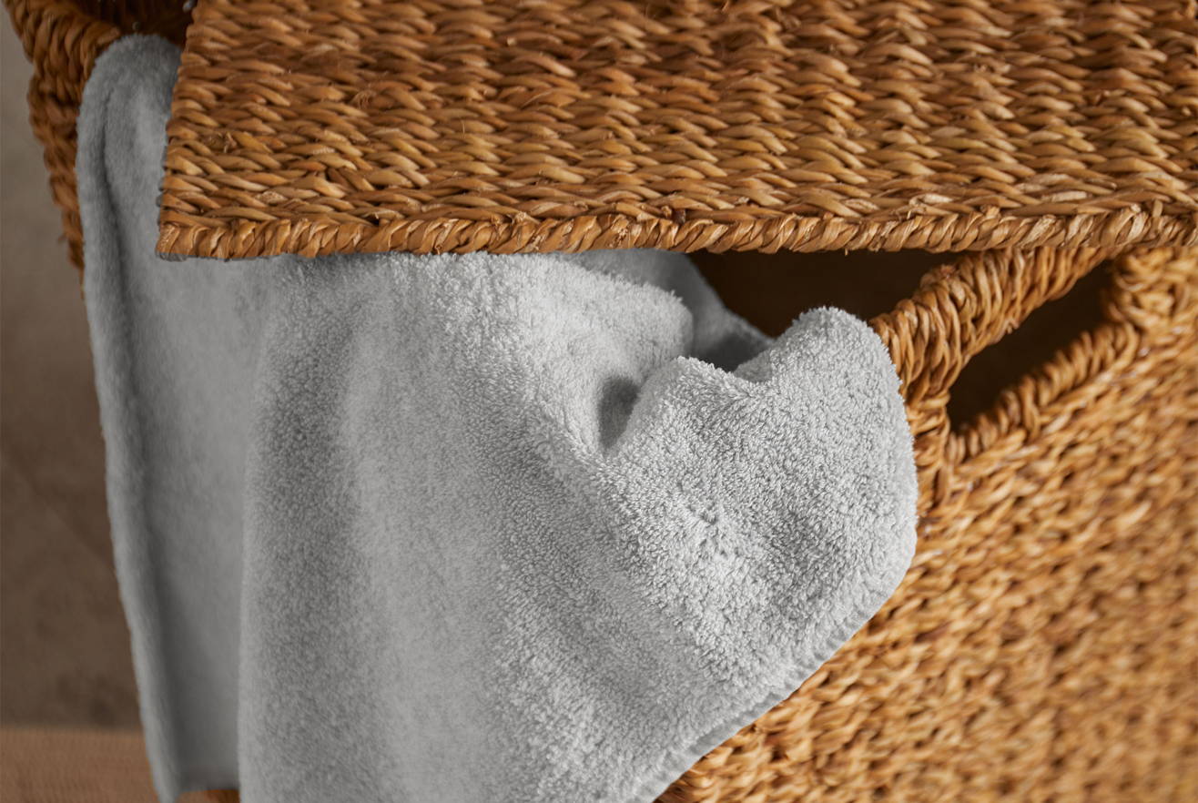 Graues Handtuch in einem Wäschekorb