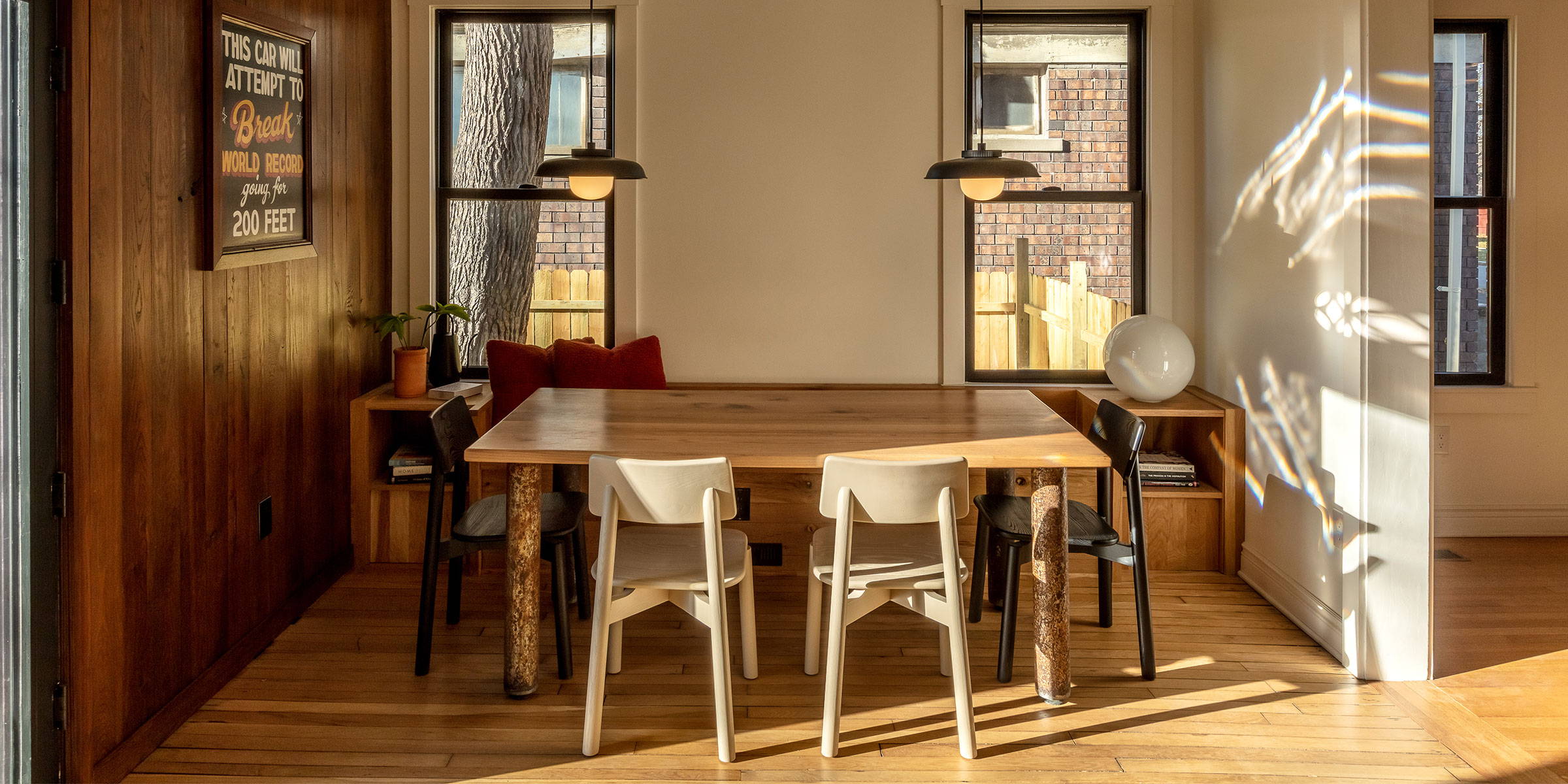 A dinning room in Detroit, MI featuring modern interior design and a reclaimed white oak table designed by Woodward Throwbacks.