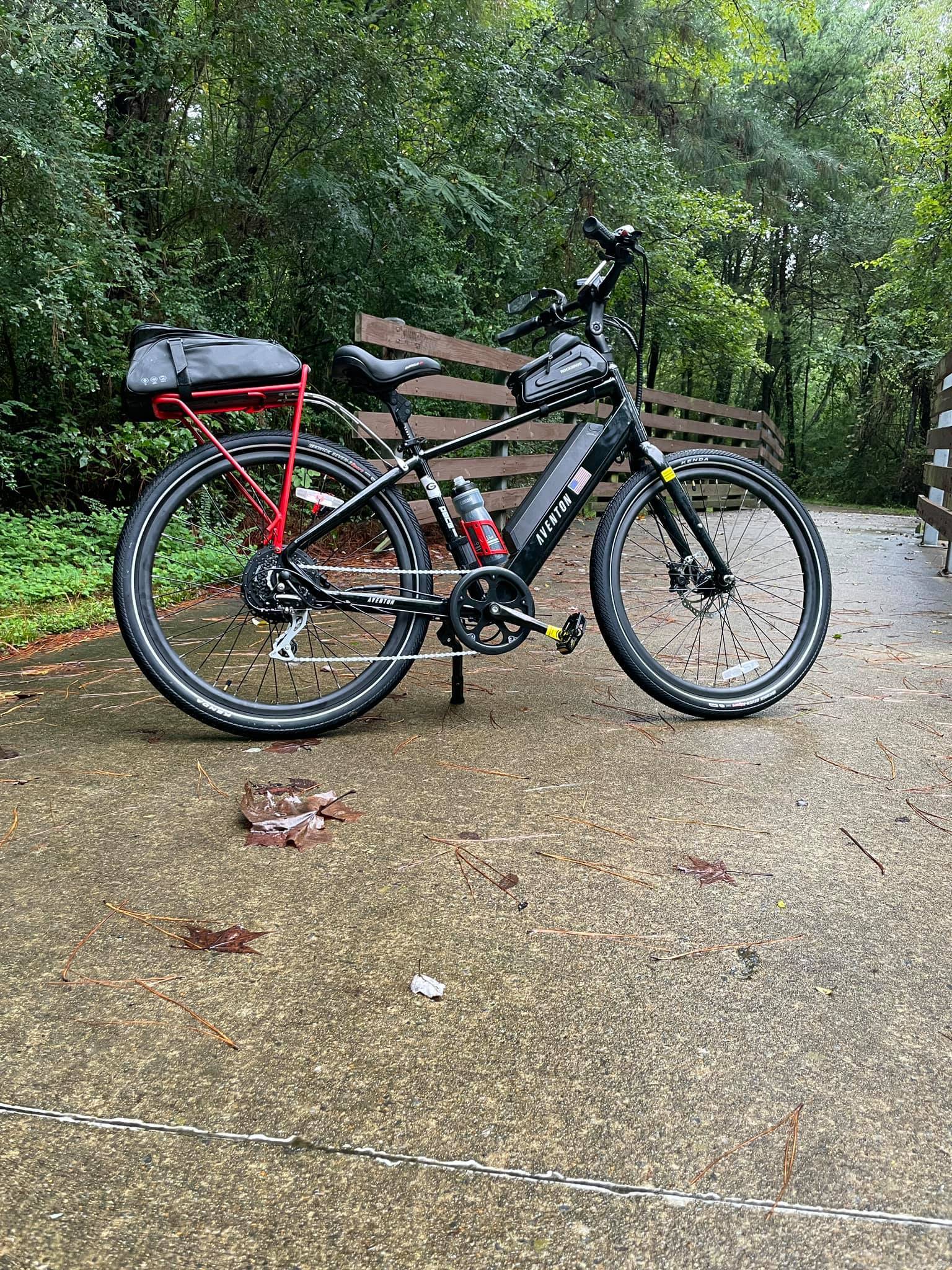 Black Aventon Level ebike with red accented rear rack and red water bottle holder.