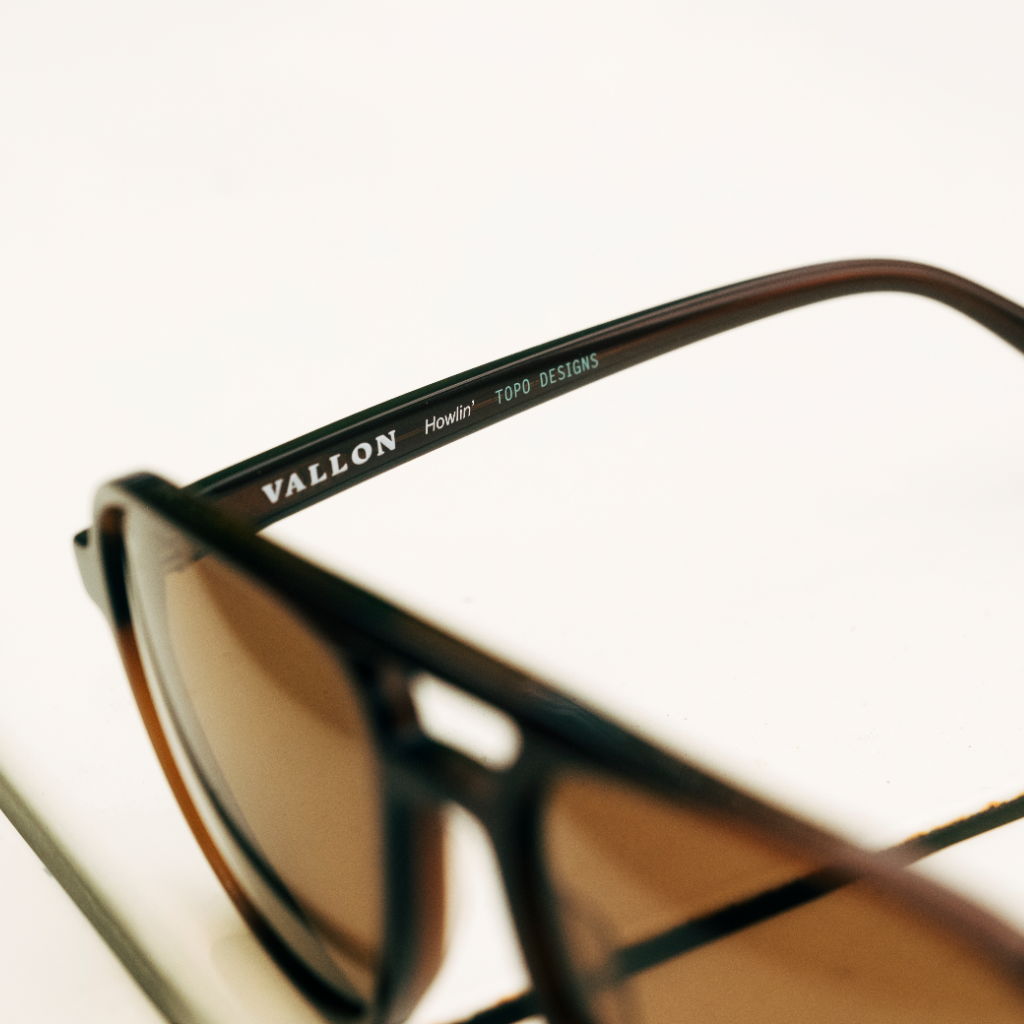 Close-up of stylish sunglasses with a dark frame and brown lenses.
