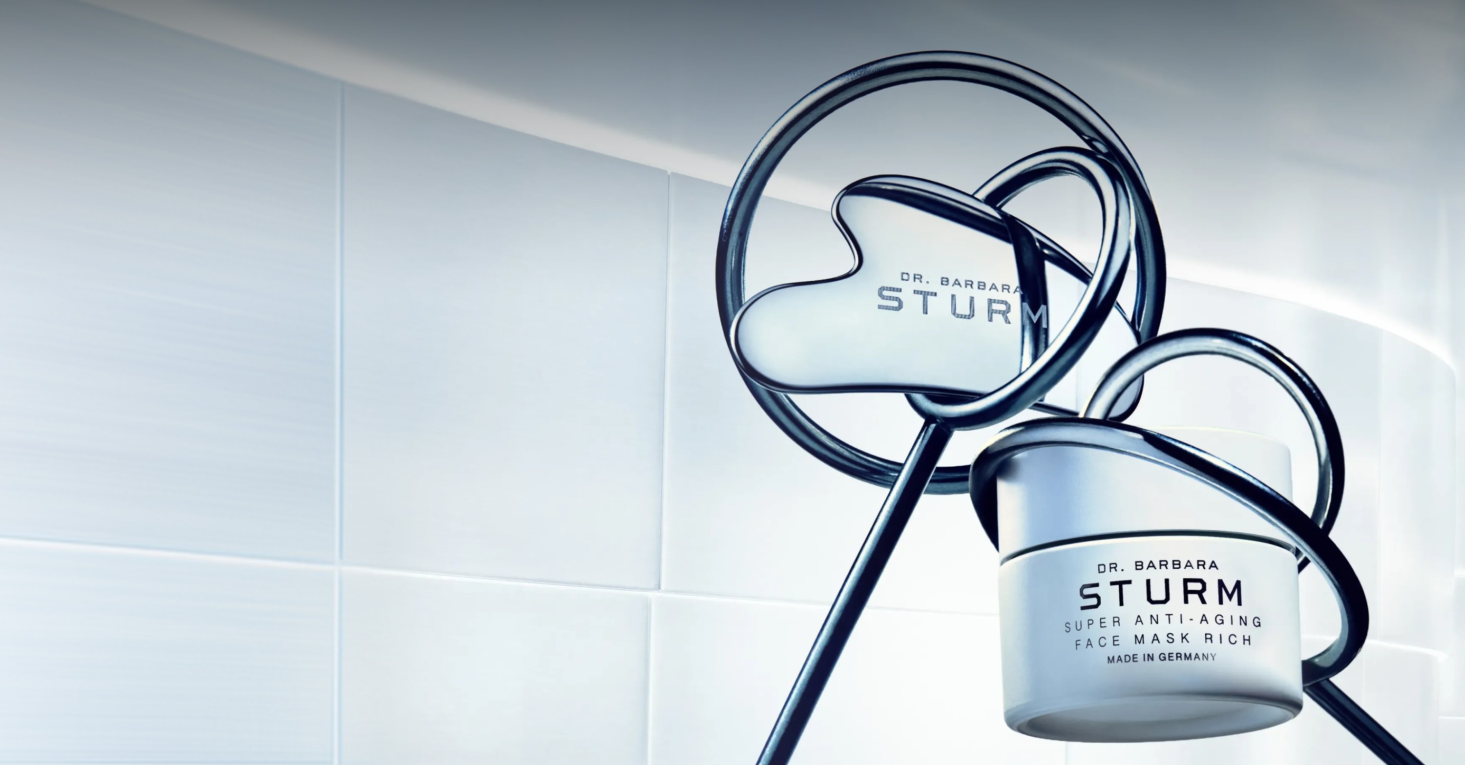 Skincare products with elegant packaging on a minimalist background.