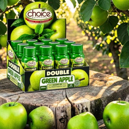 Display of green apple juice bottles among apple trees.