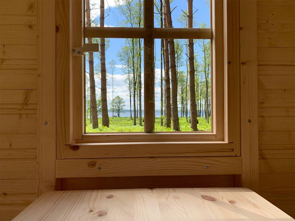 Inside view with kids table and opening safety glass window of Wooden Playhouse by WholeWoodPlayhouses 