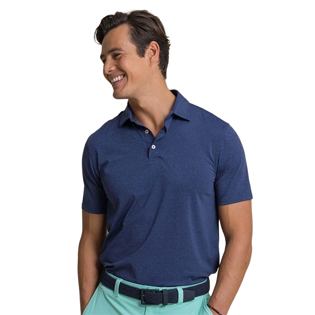 Smiling man wearing a navy polo shirt and light green pants.