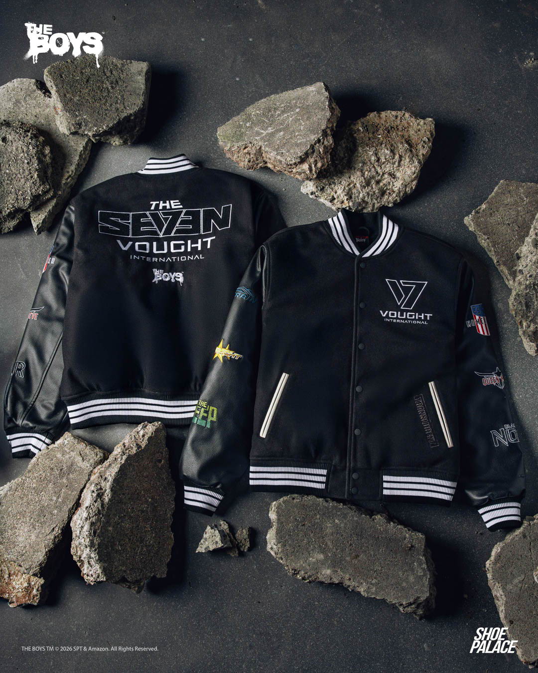 Two stylish black jackets on a rocky surface.