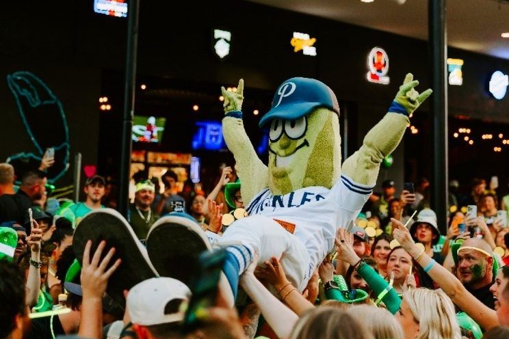 Portland Pickles mascot crowd surfing over fans at The Big Dill pickle festival in Baltimore Maryland