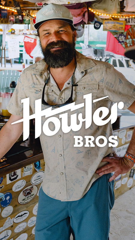 Man with beard in casual clothing at a bar. Howler Bros logo displayed.