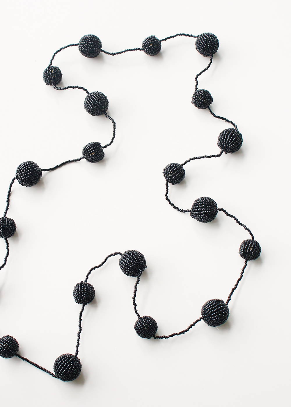 A black beaded necklace with large black spheres