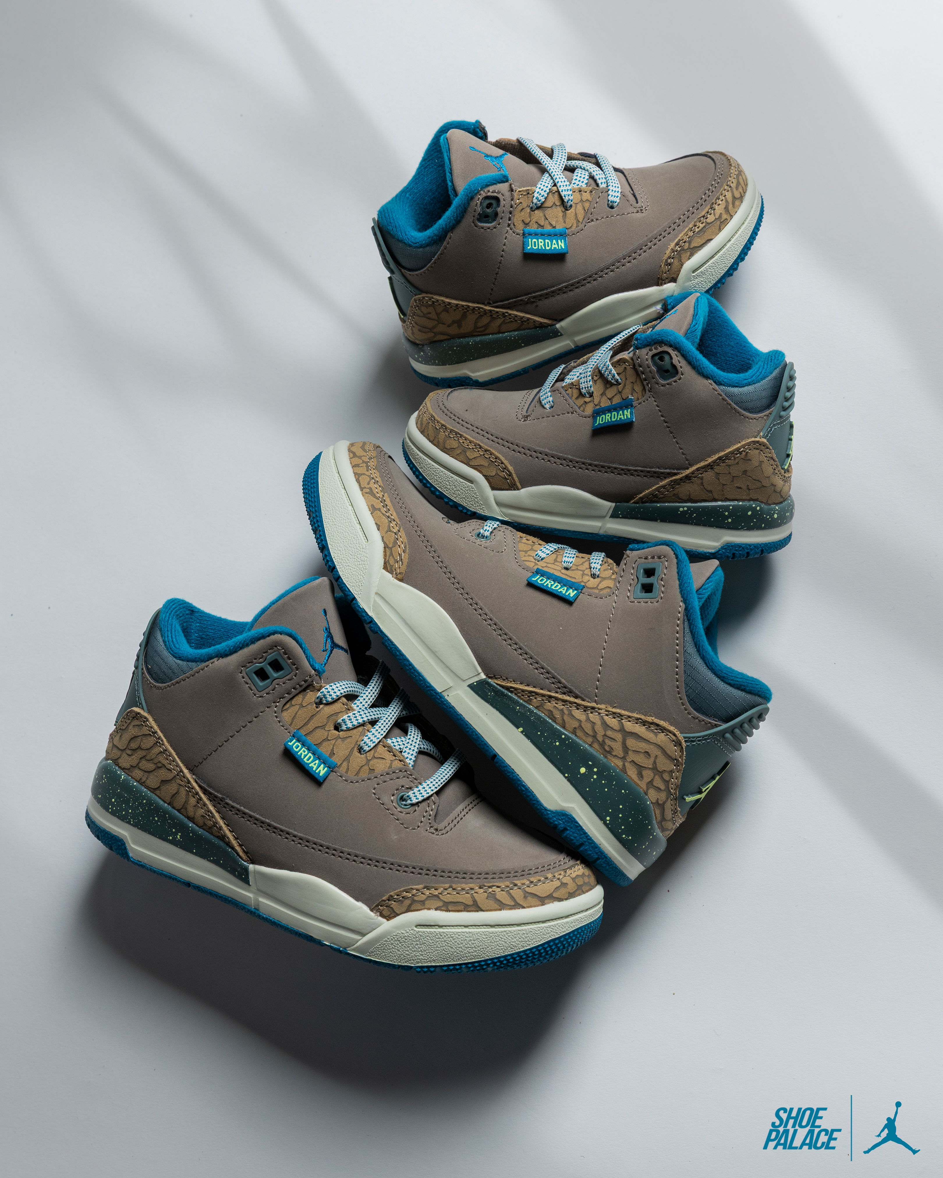 Air Jordan 3 Retro Olive Grey - Three pairs of gray and blue sneakers arranged on a surface.