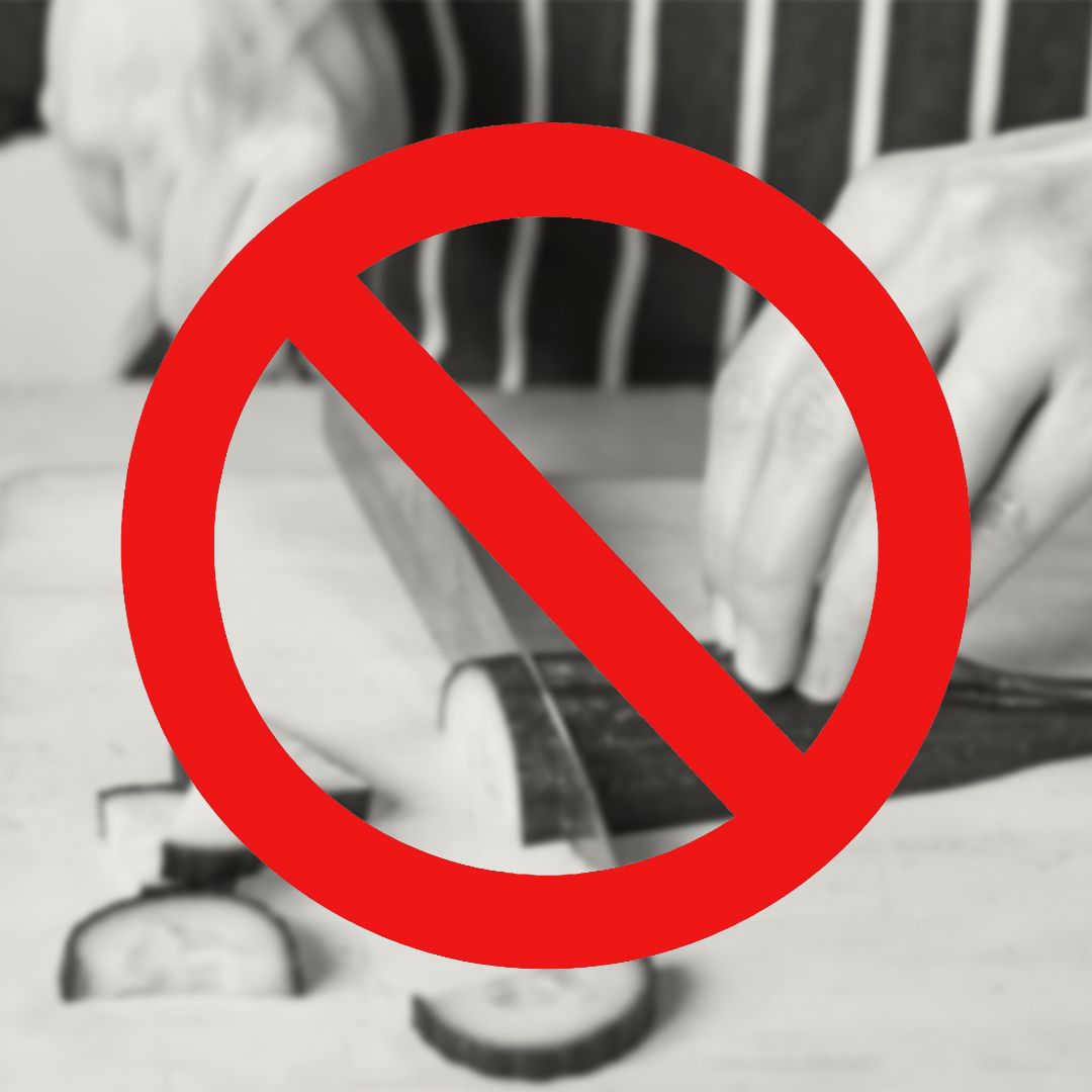 Hand slicing vegetables with a red 