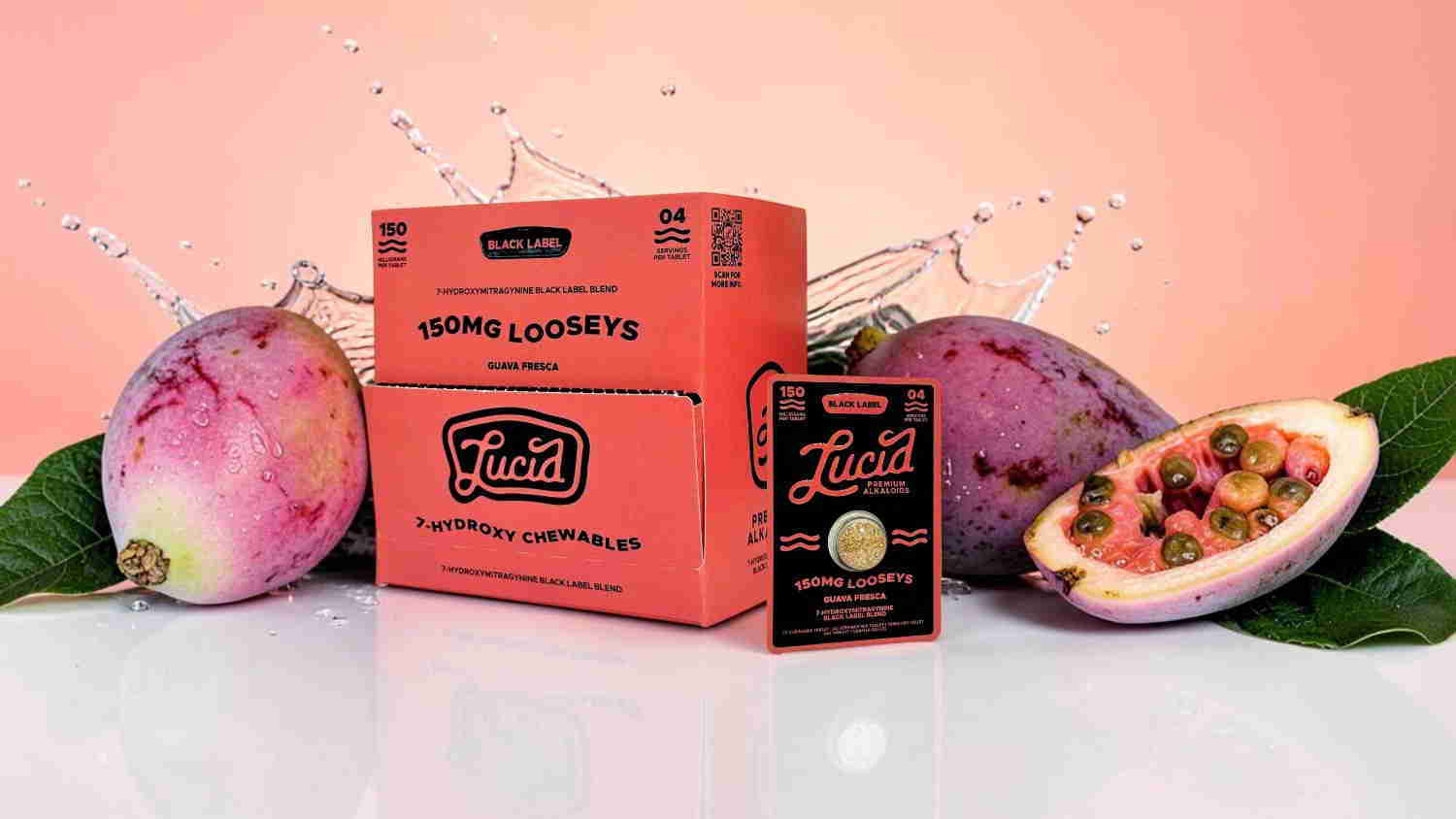 Colorful packaging surrounded by tropical fruits on a pink background.