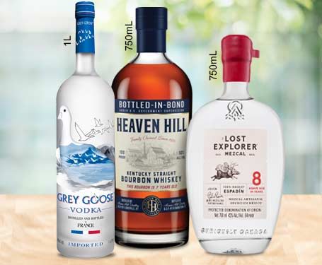 Three bottles of different spirits on a table.