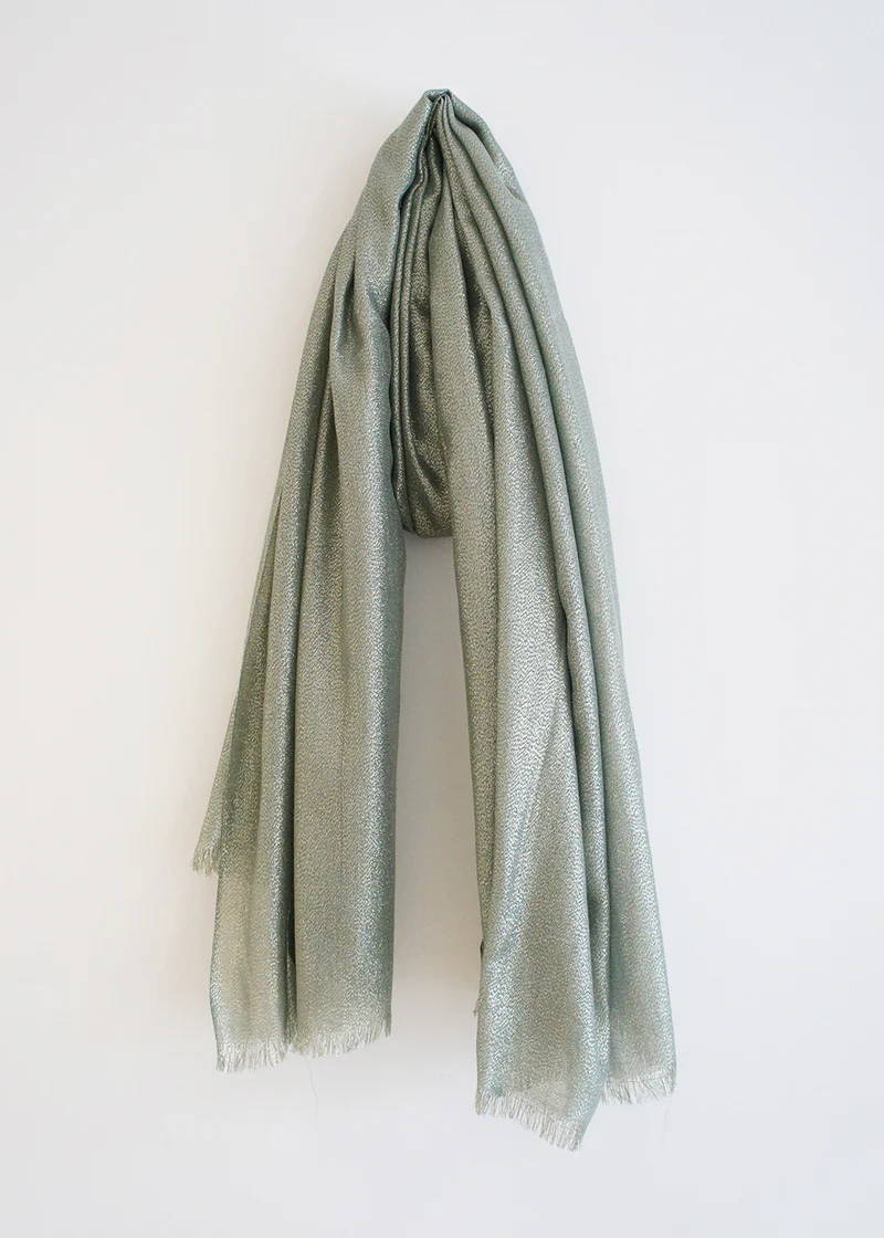 A silvery metallic scarf with raw hem detailing