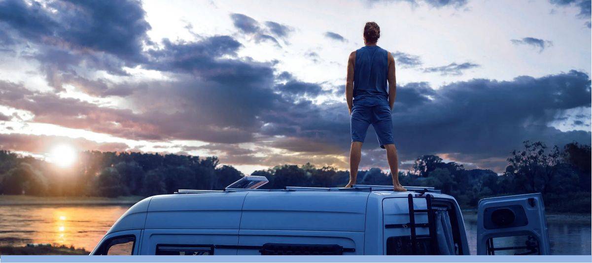 Man standing on top of an RV