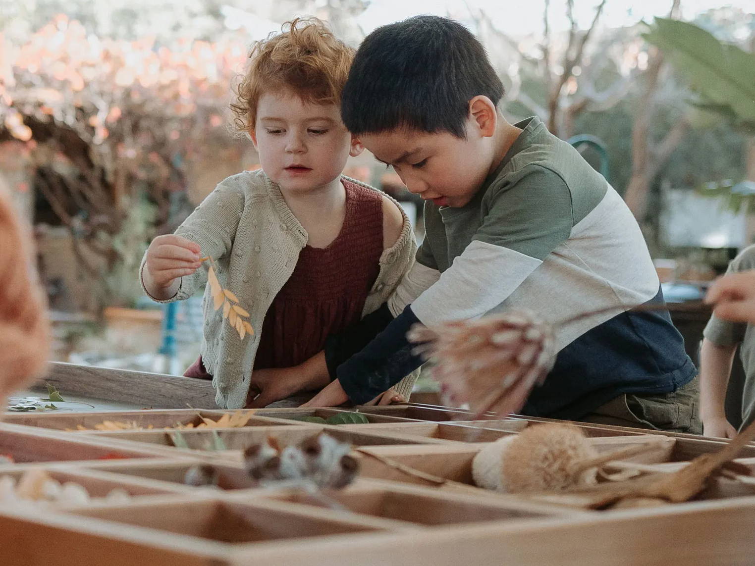 Children Engaging with Nature's Bounty on the Sensory Play Table