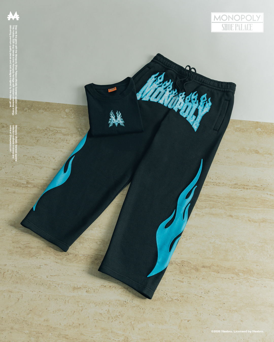 Black pants with blue flame designs on the sides.