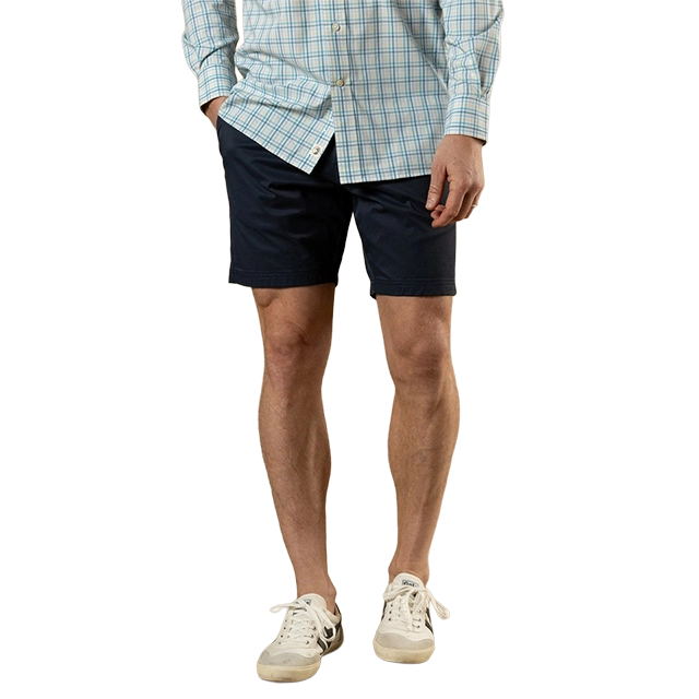 A man wearing a blue checkered shirt and navy shorts.