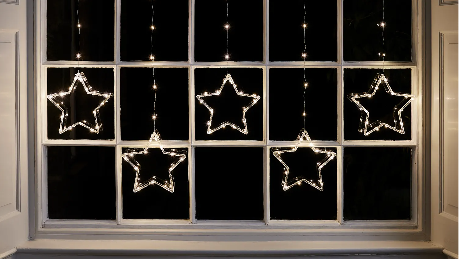 Star curtain lights in a window.