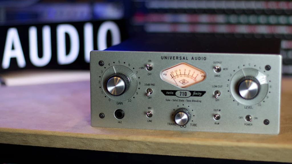 A vintage audio equipment with knobs and a meter on a wooden surface.