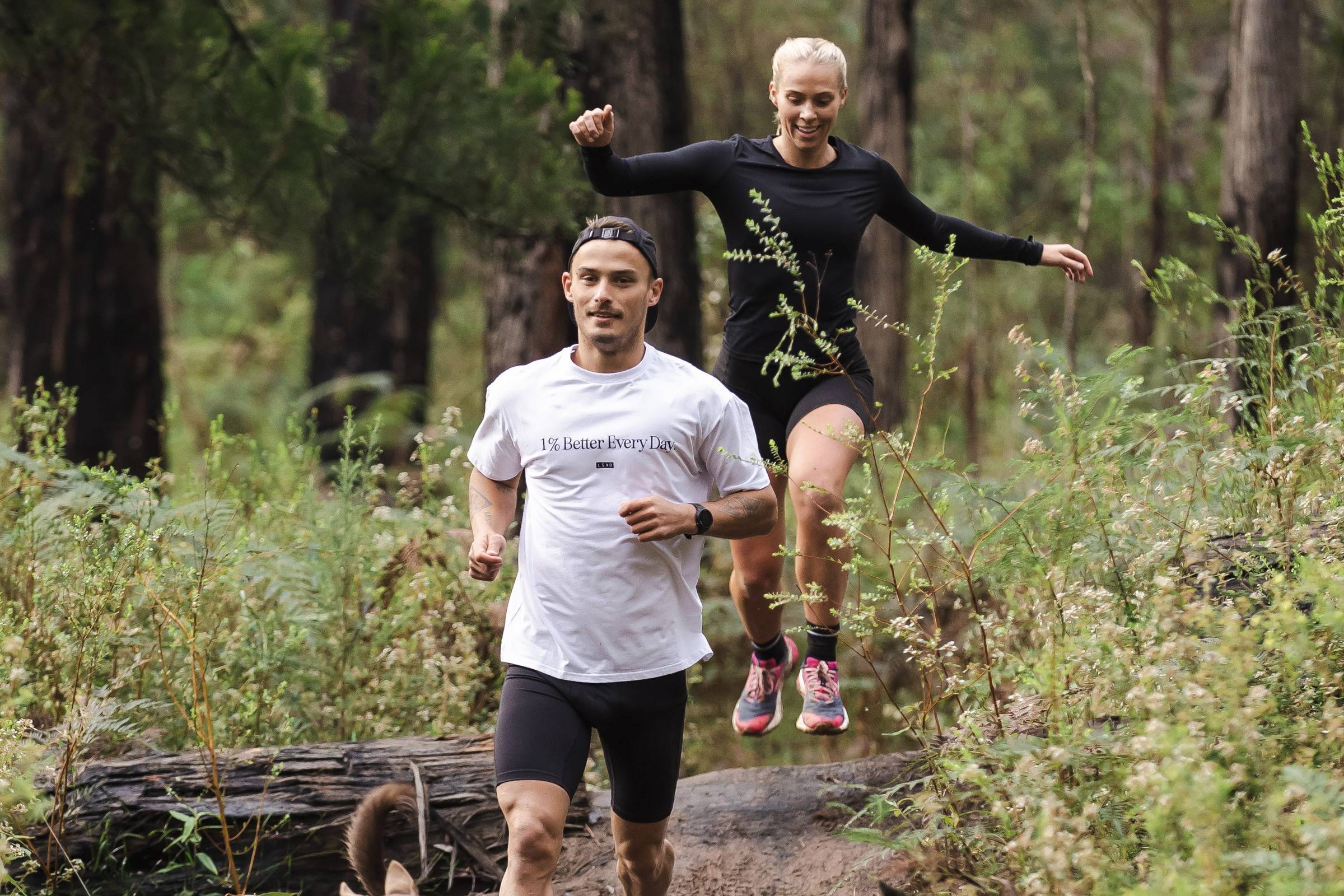 a male and female trail running 