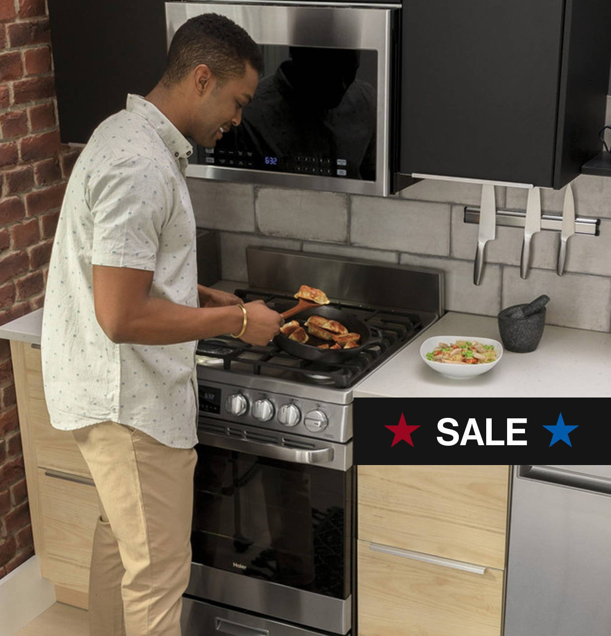 Young black man cooking food in a skillet on a Haier 24