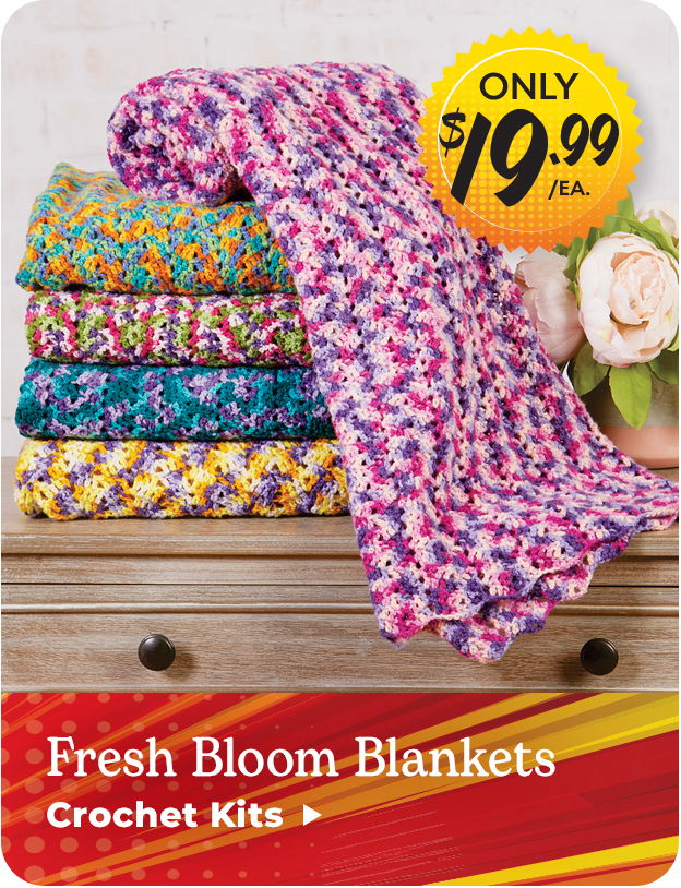 Colorful crochet blankets stacked with a price tag and flowers. Fresh Bloom Blanket Crochet Kits only $19.99