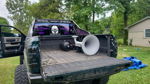 Rear view of lifted Ram pickup with tailgate down showing Kahlenberg air horn installation in bed