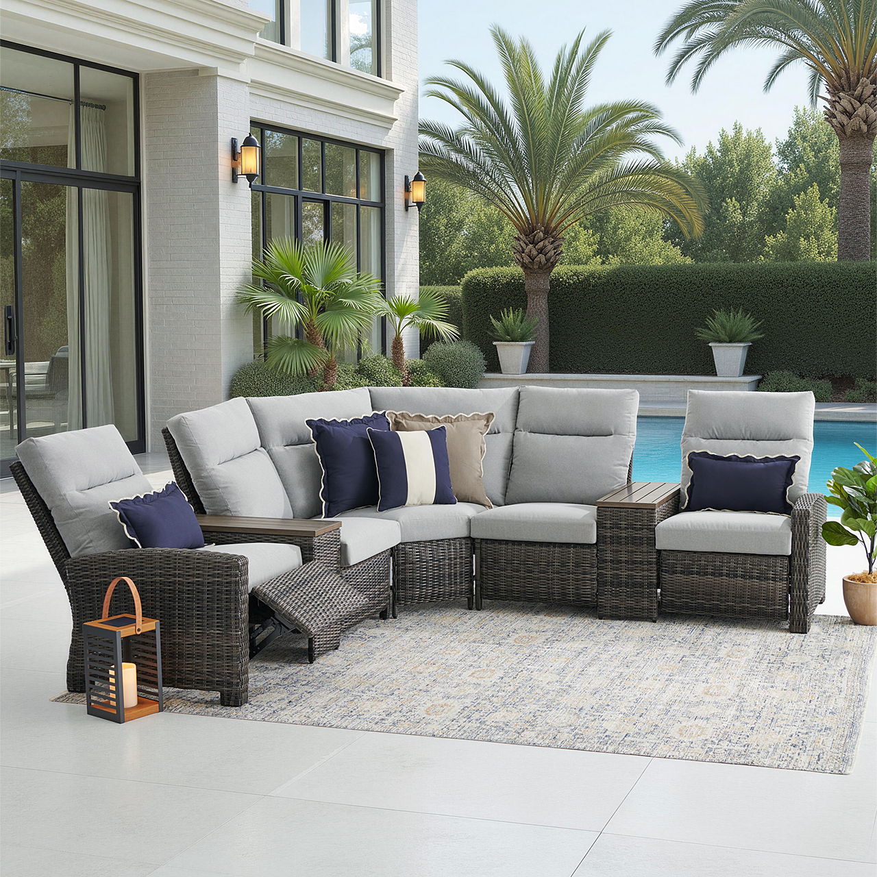 Outdoor patio furniture set near a pool with palm trees in the background.