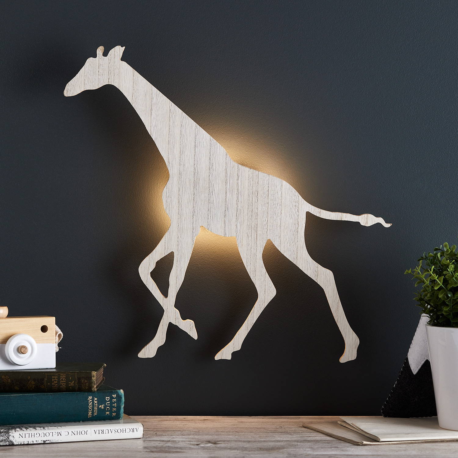 Giraffe wall light illuminated on wall