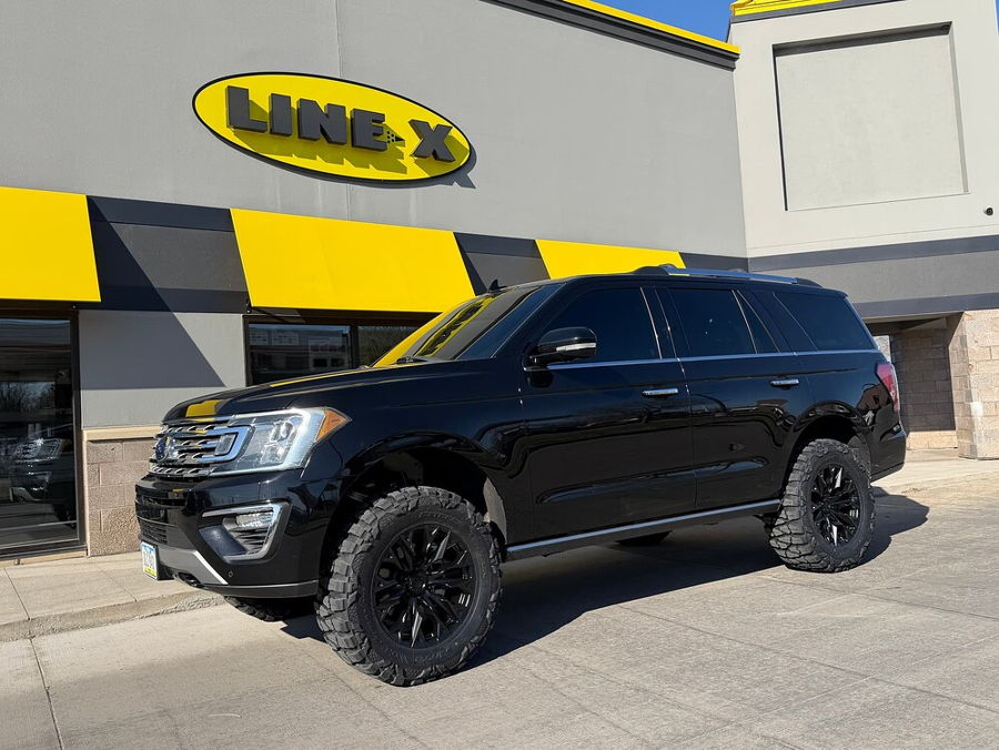 Front-three-quarter view Troy's black lifted 2018 Ford Expedition parked in front of Line-X store gallery photo 15