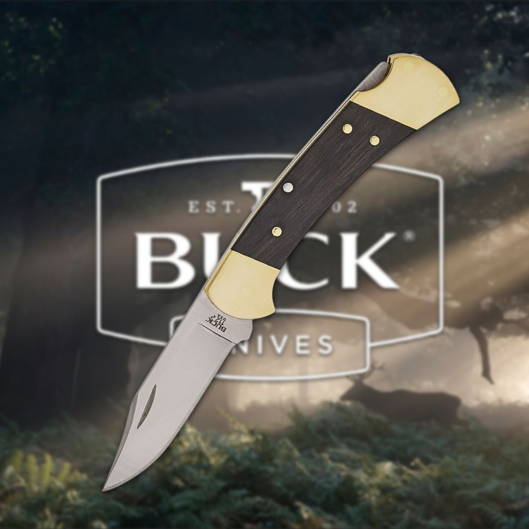 A Buck Knives folding knife against a forest background.