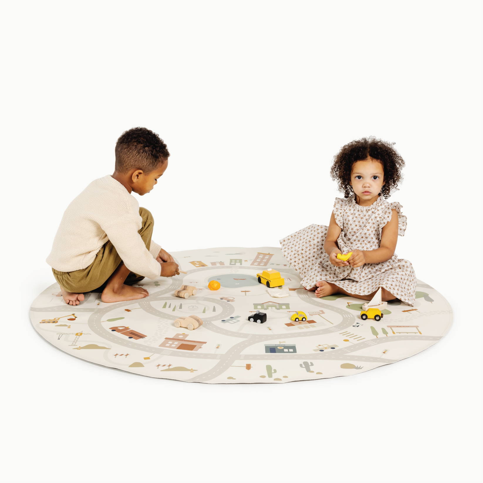 Two kids playing with cars on Gathre Playmat