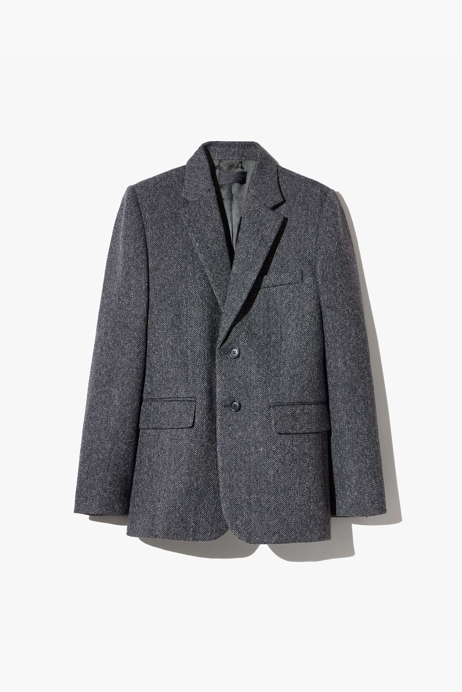 Gray blazer hanging against a white background.