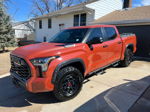 Front three-quarter Brandon's orange Solar Octane 2024 Toyota Tundra i-FORCE MAX TRD Pro camo fender flares TRD wheels BFGoodrich tires tonneau cover Nathan AirChime K5LA 544 featured customer install gallery photo 1