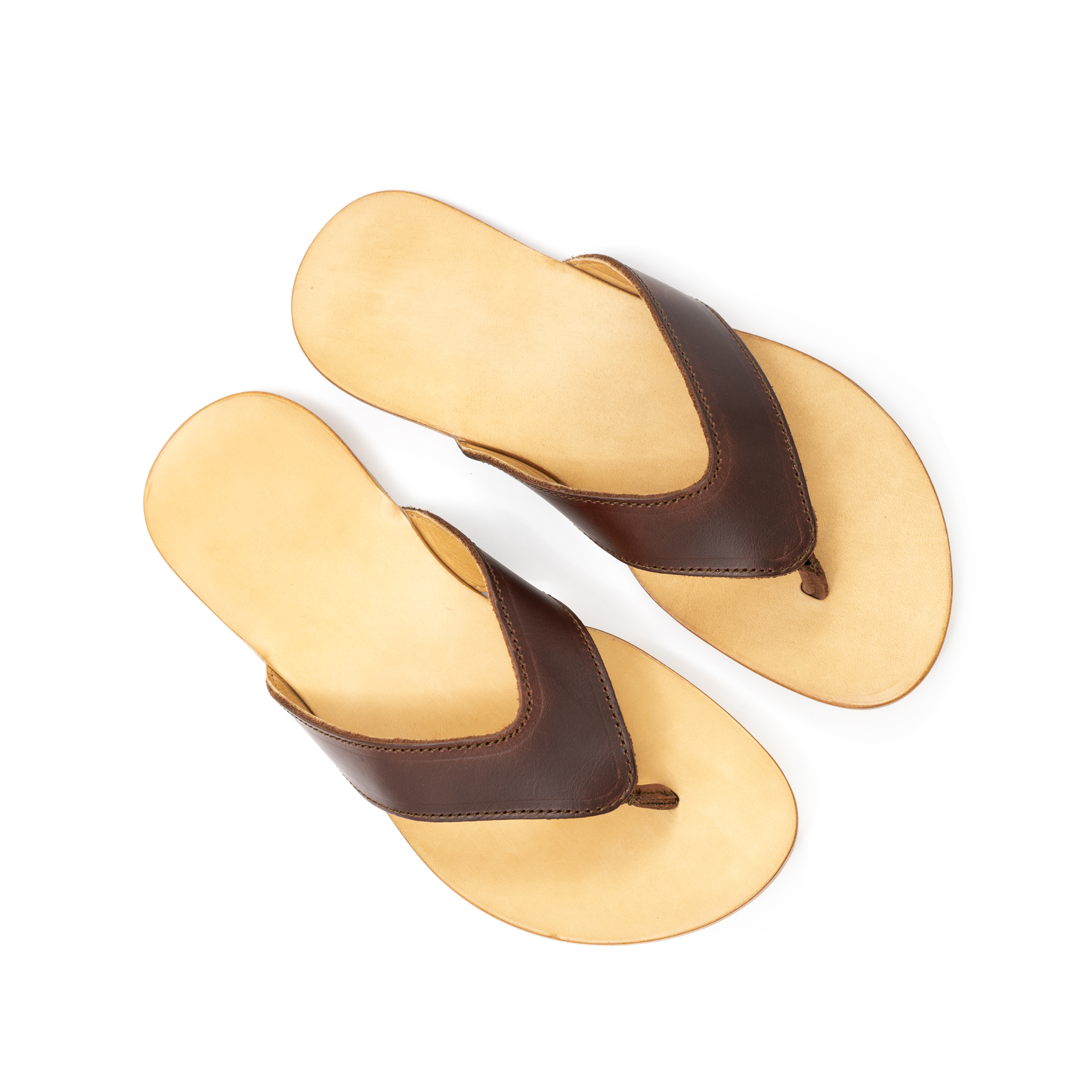 A pair of brown flip-flops on a white background.