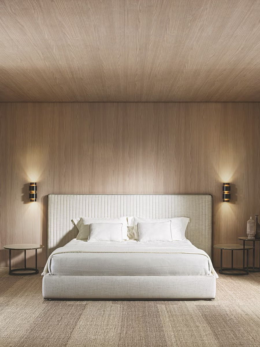 Modern bedroom with a white Ovidio bed by Molteni & C, wooden walls, and soft lighting.